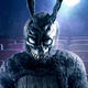 A man in a creepy rabbit suit stares at the viewer in a movie theater.